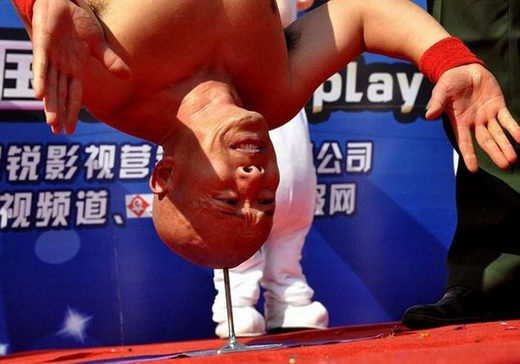 Doing a headstand on a nail